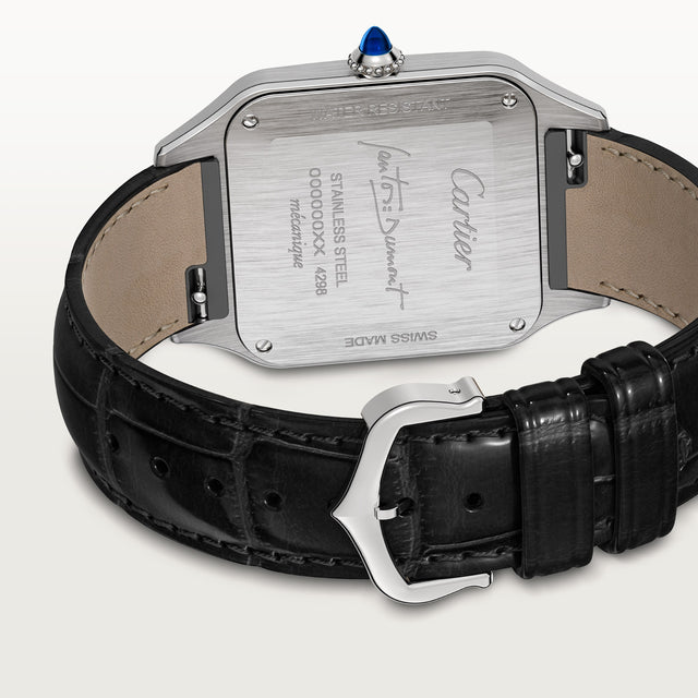 A close-up of the Cartier Santos-Dumont watch shows its stainless steel case, black leather strap, engraved details, blue gemstone crown, Cartier logo, serial number, and specifications on the back.