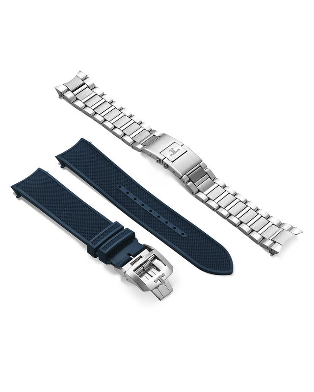 A Jaeger-LeCoultre Polaris Chronograph steel bracelet and a blue textured rubber strap with silver buckle are displayed side by side on a white background.