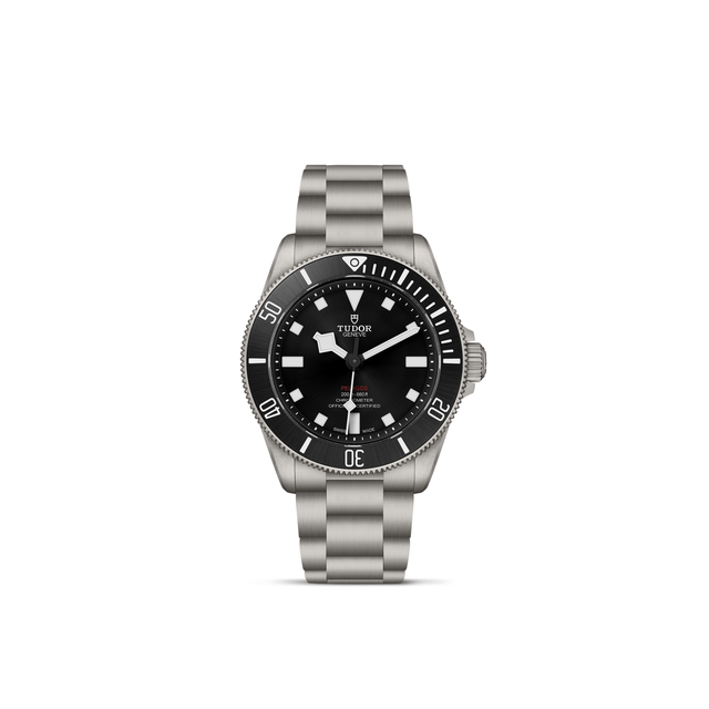The TUDOR Pelagos 39 wristwatch by TUDOR features stainless steel construction, a black unidirectional rotating bezel and dial, white hour markers, and a metal bracelet, displayed against a plain white background.